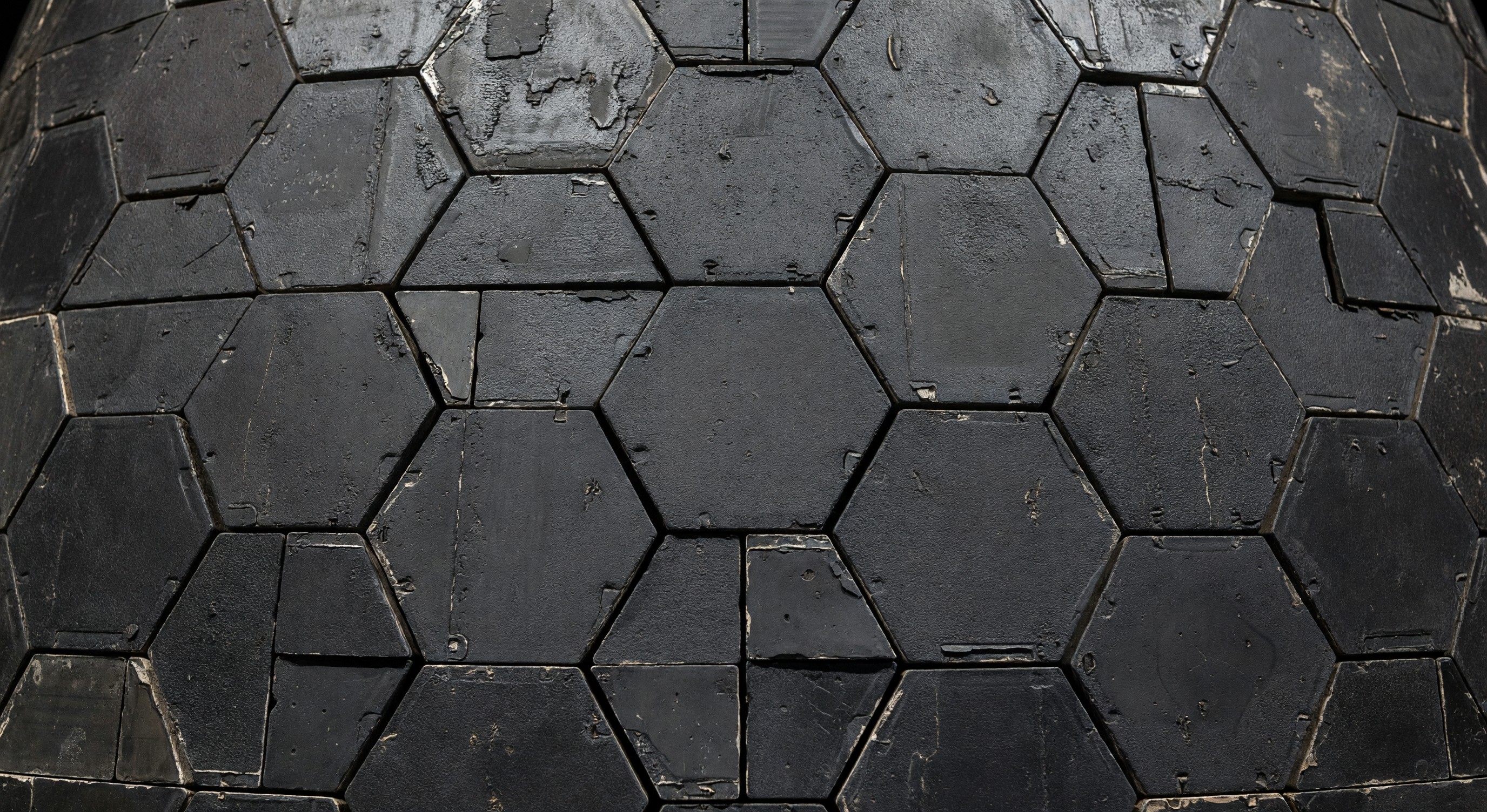 Close-up of spacecraft heat shield tiles with ablative thermal protection coating